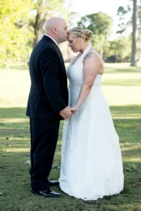 Groom blindfolded holding hands with bride before their South Shore Harbour Country Club wedding